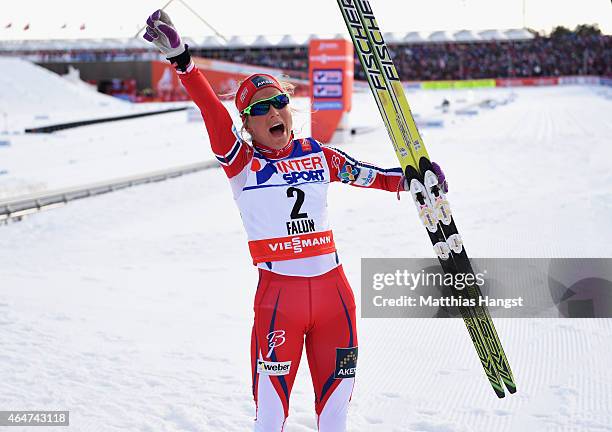 Therese Johaug of Norway celebrates winning the gold medal in the Women's 30km Mass Start Cross-Country during the FIS Nordic World Ski Championships...