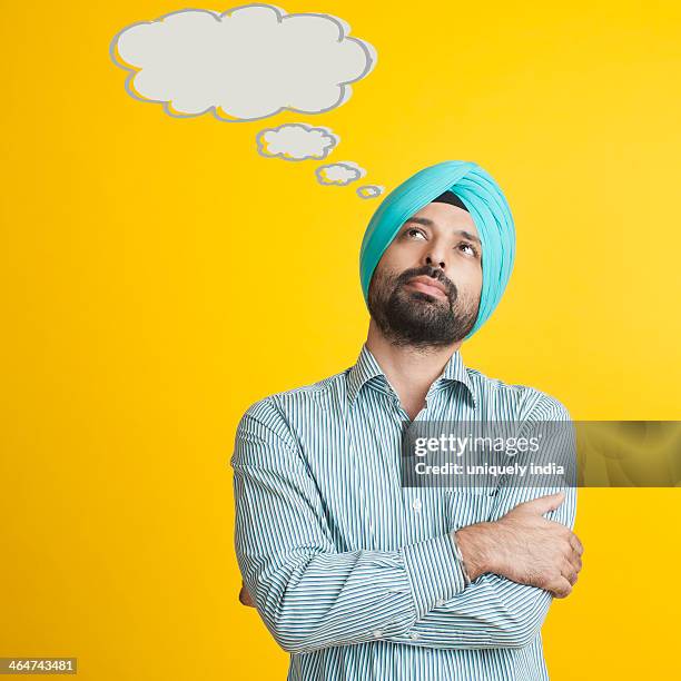 close-up of a sikh man thinking - turban stock pictures, royalty-free photos & images