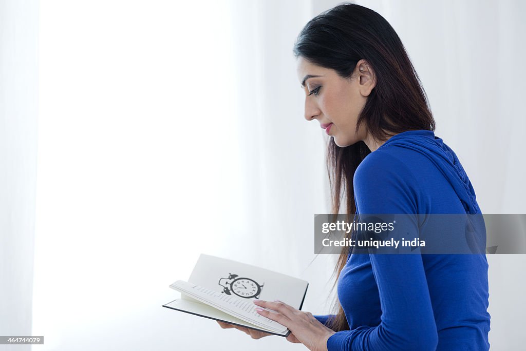 Side profile of a woman reading a book