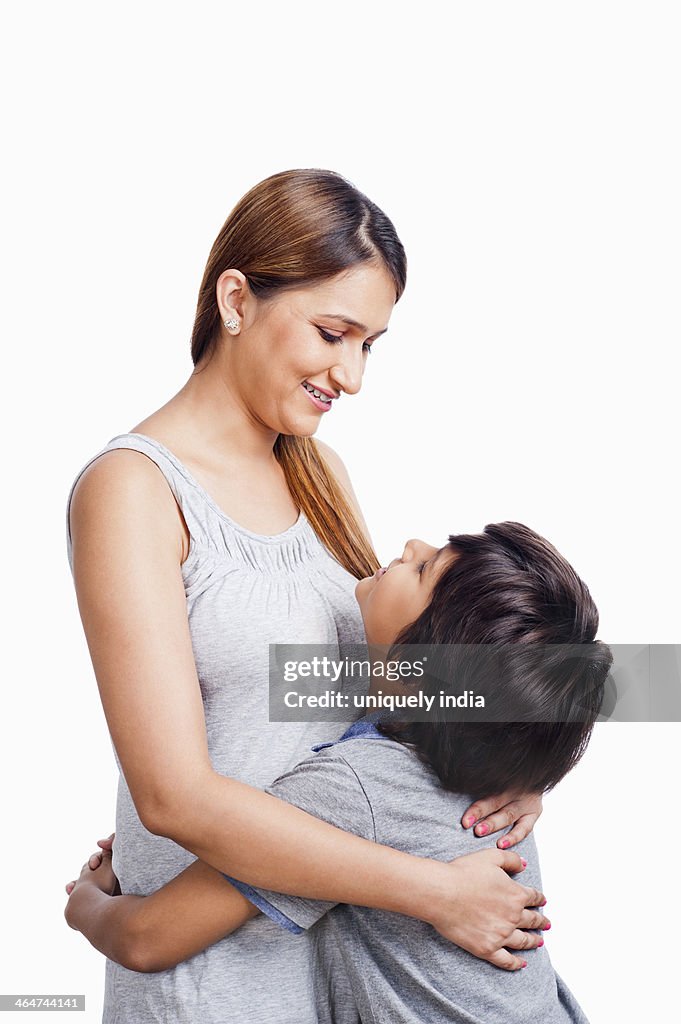 Woman and her son hugging each other and smiling