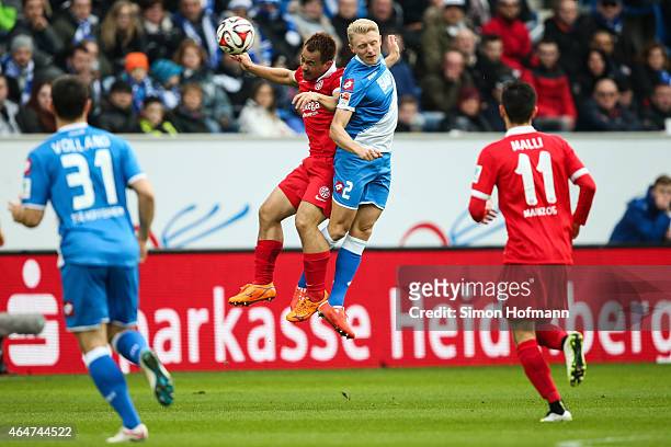 Andreas Beck of Hoffenheim jumps for a header with Shinji Okazaki of Mainz during the Bundesliga match between 1899 Hoffenheim and 1. FSV Mainz 05 at...