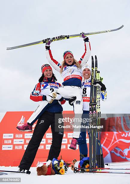 Gold medallist Therese Johaug of Norway celebrates with silver medallist Marit Bjoergen of Norway and bronze medallist Charlotte Kalla of Sweden...