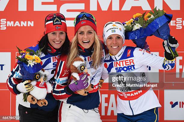 Gold medallist Therese Johaug of Norway celebrates with silver medallist Marit Bjoergen of Norway and bronze medallist Charlotte Kalla of Sweden...