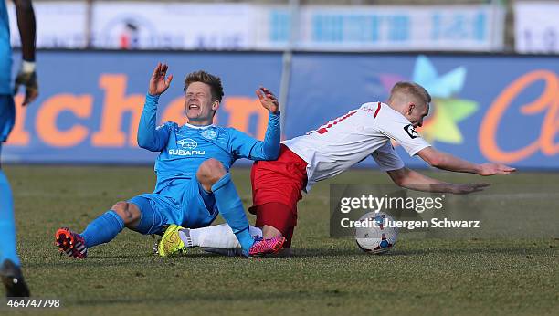 Thomas Kraus of Cologne tackles Bentley Baxter Bahn of Stuttgart during the 3rd Bundesliga match between Fortuna Koeln and Stuttgarter Kickers at...