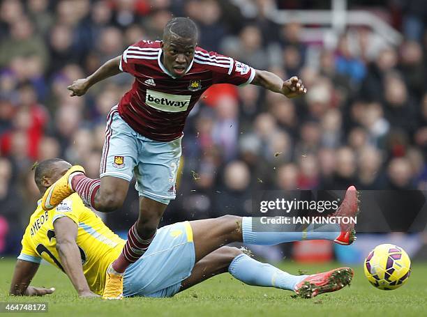 West Ham United's Ecuadorian striker Enner Valencia avoids the tackle from Crystal Palace's Nigerian striker Shola Ameobi during the English Premier...