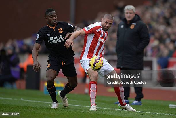 Jonathan Walters of Stoke City competes with Maynor Figueroa of Hull City during the Barclays Premier League match between Stoke City and Hull City...
