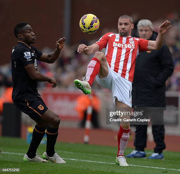 Jonathan Walters of Stoke City competes with Maynor Figueroa of Hull City during the Barclays Premier League match between Stoke City and Hull City...