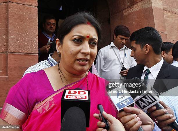 Minister Smriti Irani talks with media during the Budget session at the Parliament House on February 28, 2015 in New Delhi, India. Union Finance...