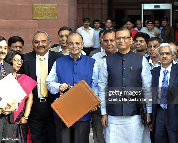 Finance Minister Arun Jaitley holding budget papers and his MOS Jyant Sinha with finance secretaries leaving his office for the Parliament to present...