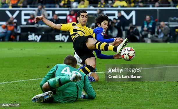 Henrikh Mkhitaryan of Borussia Dortmund scores his teams second goal next to Atsuto Uchida of Schalke 04 during hte Bundesliga match between Borussia...