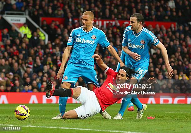 Radamel Falcao García of Manchester United is brought down in the area by Wes Brown and John O'Shea of Sunderland to win a penalty during the...