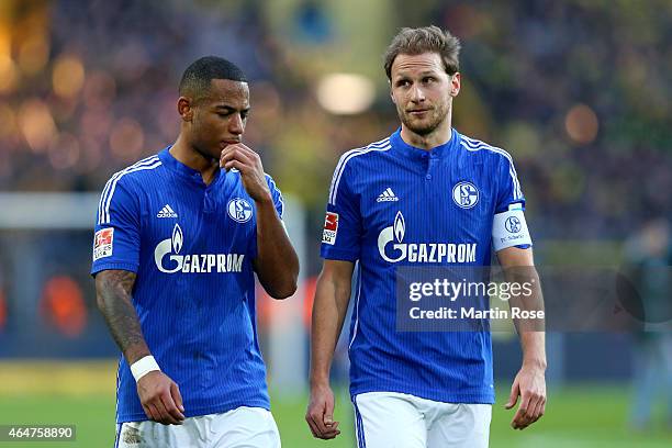 Dennis Aogo of Schalke reacts with his team mate Benedik Hoewedes after the Bundesliga match between Borussia Dortmund and FC Schalke 04 at Signal...