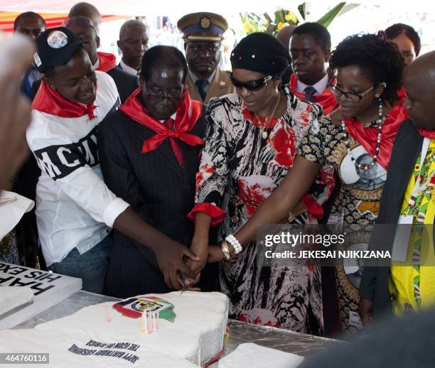 Zimbabwean President Robert Mugabe , lady Grace Mugabe and his daughter Bona cut a birthday cake on February 28, 2015 during the celebration of...