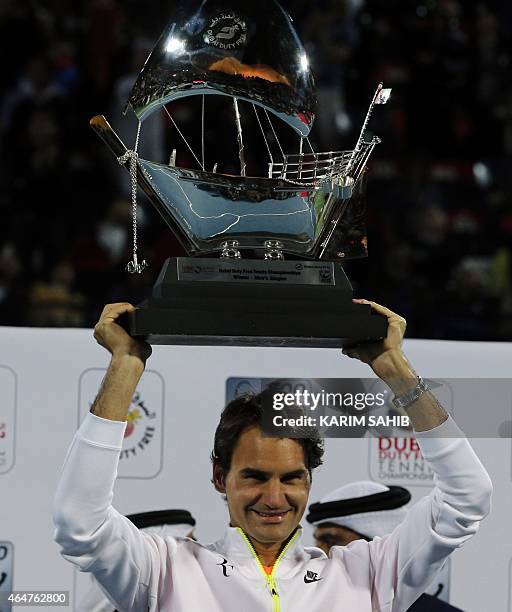 Roger Federer of Switzerland poses with the ATP Dubai Duty Free Tennis Championships trophy after defeating World number one Novak Djokovic of Serbia...