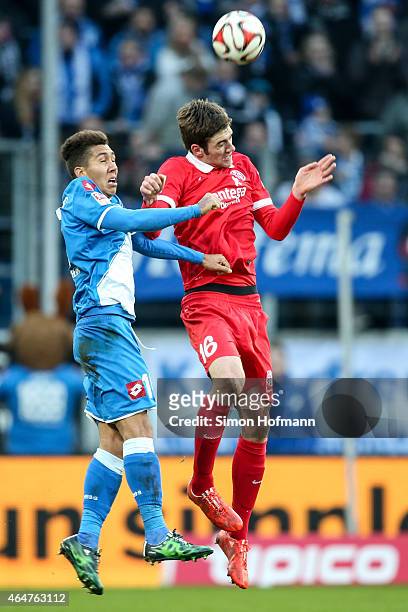 Stefan Bell of Mainz jumps for a header with Roberto Firmino of Hoffenheim during the Bundesliga match between 1899 Hoffenheim and 1. FSV Mainz 05 at...