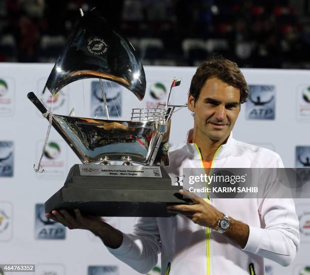 Roger Federer of Switzerland poses with the ATP Dubai Duty Free Tennis Championships trophy after defeating World number one Novak Djokovic of Serbia...