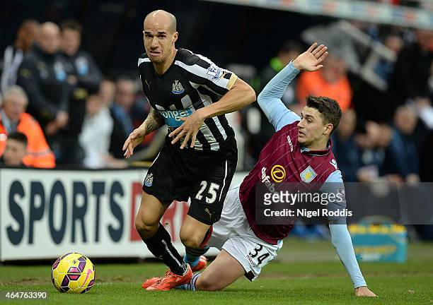 Gabriel Obertan of Newcastle United breaks away from Matthew Lowton of Aston Villa during the Barclays Premier League match between Newcastle United...