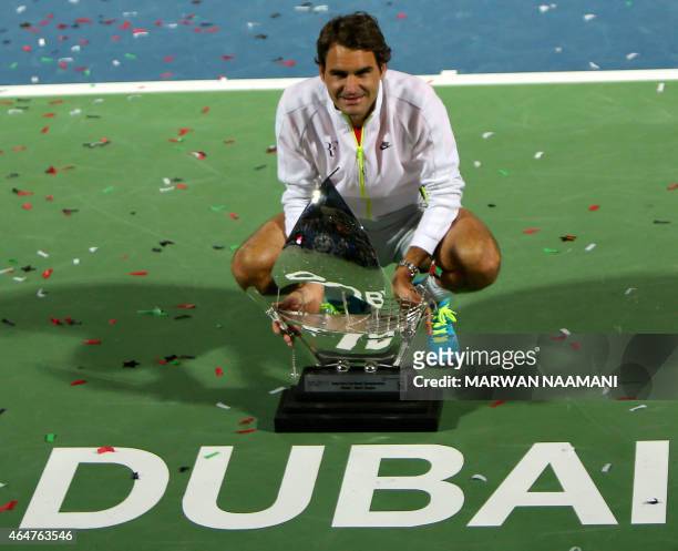 Roger Federer of Switzerland poses with the ATP Dubai Duty Free Tennis Championships trophy after defeating World number one Novak Djokovic of Serbia...
