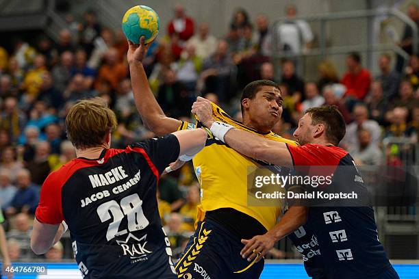 Mads Mensah Larsen of Rhein-Neckar Loewen is challenged by Jakob Macke of Flensburg and Tobias Karlsson of Flensburg during the DKB HBL Bundesliga...