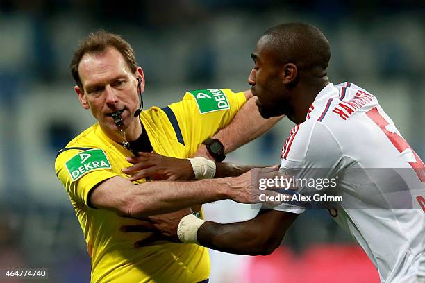 Johan Djourou of Hamburg reacts with referee Florian Meyer during the Bundesliga match between Eintracht Frankfurt and Hamburger SV at...