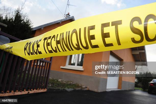 Picture taken on January 24, 2014 shows a banner reading "technical police" in front of a house where a man could killed a man during the night in...