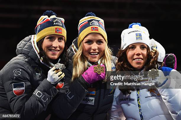 Gold medallist Therese Johaug of Norway poses with silver medallist Marit Bjoergen of Norway and bronze medallist Charlotte Kalla of Sweden during...