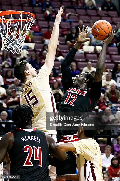 Boris Bojanovsky of the Florida State Seminoles attempts to block the shoot of Mangok Mathiang of the Louisville Cardinals during the game at the...