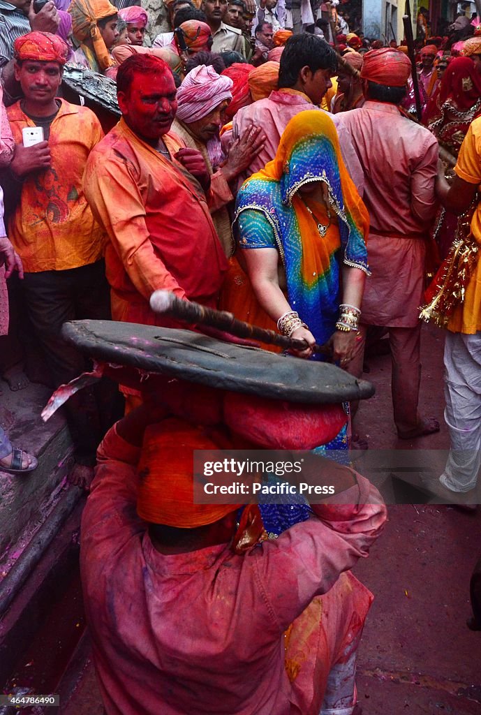 Women of Barsana beating men of Nandgaon with sticks during...