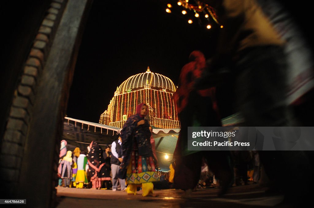 Devotees arrives at an illuminated decorated with colourful...