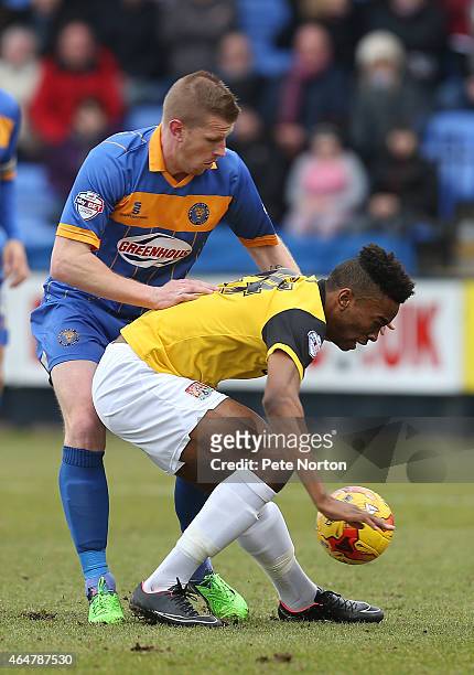 Ivan Toney of Northampton Town attempts to control the ball under pressure from Keith Southern of Shrewsbury Town during the Sky Bet League Two match...