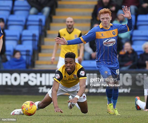 Ivan Toney of Northampton Town goes to ground as he attempts to move away from Ryan Woods of Shrewsbury Town during the Sky Bet League Two match...