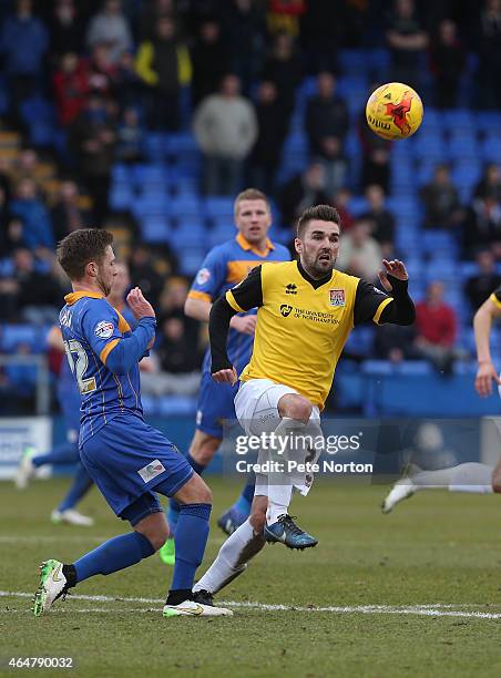 Ricky Holmes of Northampton Town contests the ball with Jordan Clark of Shrewsbury Town during the Sky Bet League Two match between Shrewsbury Town...