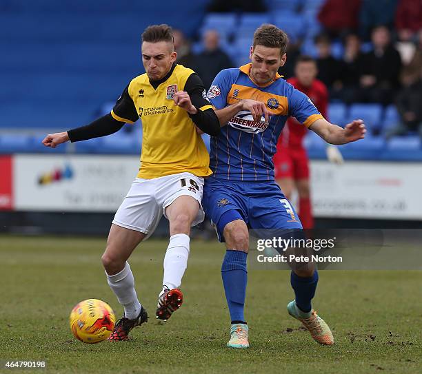 Lawson D'Ath of Northampton Town contests the ball with Micky Demetriou of Shrewsbury Town during the Sky Bet League Two match between Shrewsbury...