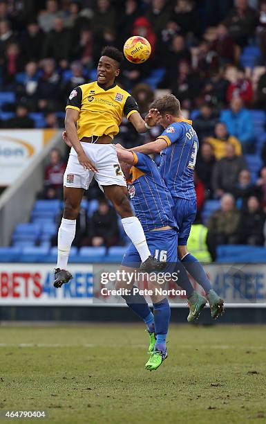 Ivan Toney of Northampton Town challenges for the ball with Micky Demetriou and Keith Southern of Shrewsbury Town during the Sky Bet League Two match...