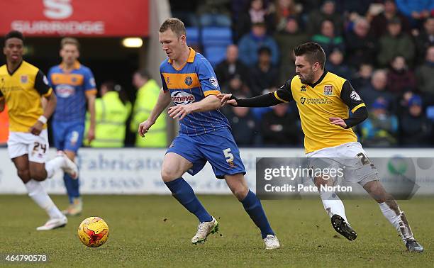 Mark Ellis of Shrewsbury Town moves away with the ball watched by Ricky Holmes of Northampton Town during the Sky Bet League Two match between...