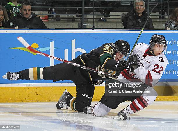 Pius Suter of the Guelph Storm crashes into Julius Bergman of the London Knights during an OHL game at Budweiser Gardens on February 27, 2015 in...