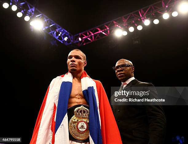 Chris Eubank Jnr is watched by his father Chris Eubank as he celebrates victory over Dmitry Chudinov for the WBA Interim World Middleweight...
