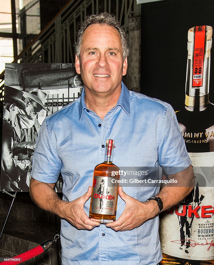 Actor Ethan Wayne Signs Bottles Of Duke Bourbon During 2015 PHS Philadelphia Flower Show