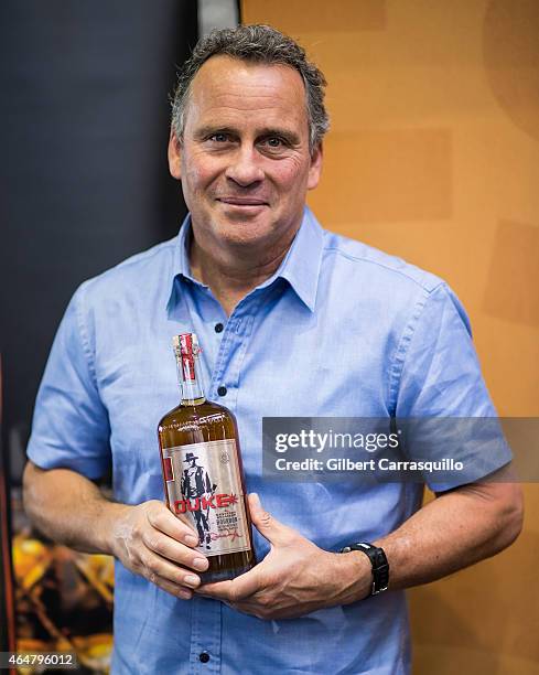 Actor Ethan Wayne, son of actor John Wayne, signs bottles of Duke Bourbon during 186th PHS Philadelphia Flower Show, "Celebrate the Movies", at...