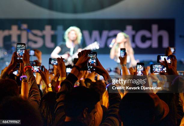 Fans using smart phones record the performance byTori Kelly and surprise guest singer Ariana Grande during MTV's 2014 "Artist To Watch" kickoff event...