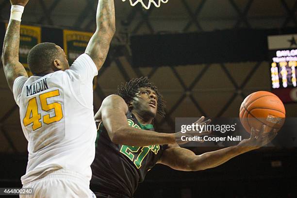 Taurean Prince of the Baylor Bears drives to the basket against Elijah Macon of the West Virginia Mountaineers on February 28, 2015 at the Ferrell...