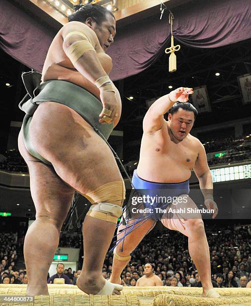 Tamawashi pushes out Toyonoshima during day twelve of the Grand Sumo New Year Tournament at Ryogoku Kokugikan on January 23, 2014 in Tokyo, Japan.