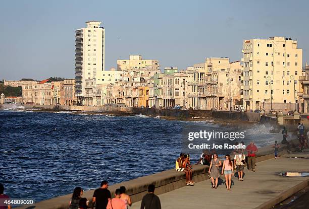 People walk along the Malecon a day after the second round of diplomatic talks between the United States and Cuban officials took place in...