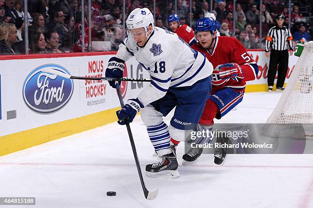 Richard Panik of the Toronto Maple Leafs stick handle the puck while being defended by Sergei Gonchar of the Montreal Canadiens during the NHL game...