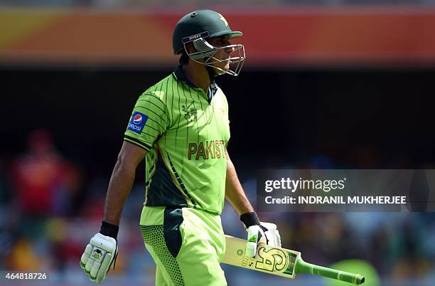 Pakistan cricketer Nasir Jamshed walks back after being dismissed by Zimbabwe during the 2015 Cricket World Cup Pool B match between Pakistan and...