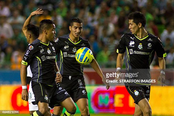 Rodolfo Salinas , Diego Gonzalez and Jesus Molina of Santos try to control the ball during a match between Leon and Santos Laguna as part of 8th...