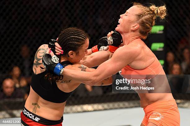 Raquel Pennington punches Holly Holm in their women's bantamweight bout during the UFC 184 event at Staples Center on February 28, 2015 in Los...