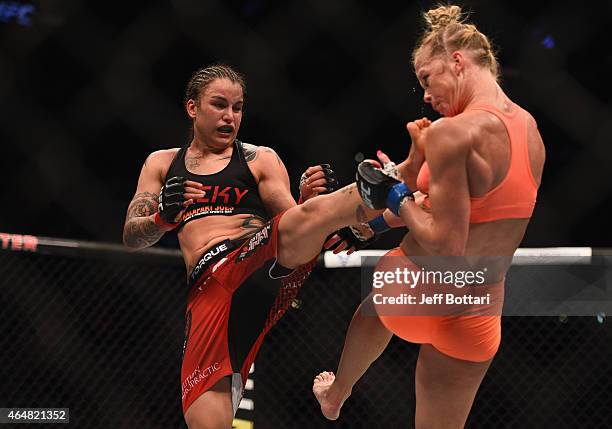 Raquel Pennington kicks Holly Holm in their women's bantamweight bout during the UFC 184 event at Staples Center on February 28, 2015 in Los Angeles,...