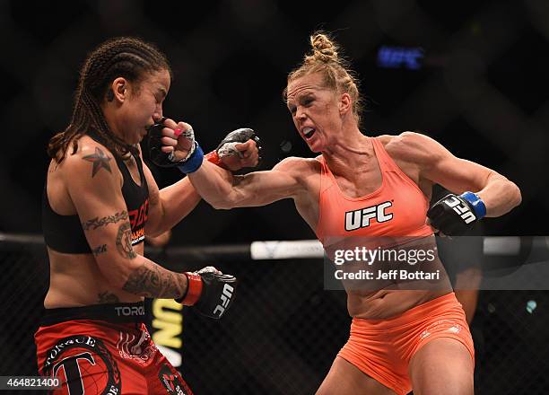 Holly Holm punches Raquel Pennington in their women's bantamweight bout during the UFC 184 event at Staples Center on February 28, 2015 in Los...