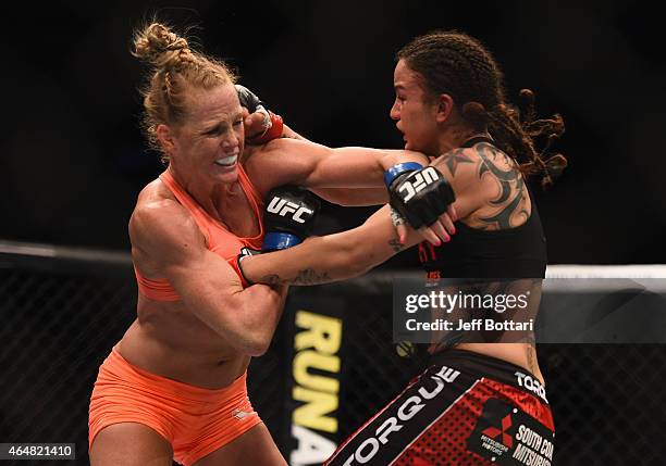 Holly Holm and Raquel Pennington exchange punches in their women's bantamweight bout during the UFC 184 event at Staples Center on February 28, 2015...